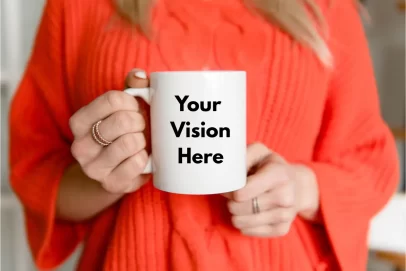 Woman holding a white mug with the words “Your Vision Here,” showcasing a customizable product example from a print on demand course.
