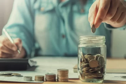 A family county money at the kitchen table, showing how following the $1,000 a month savings rule can make you a millionaire.