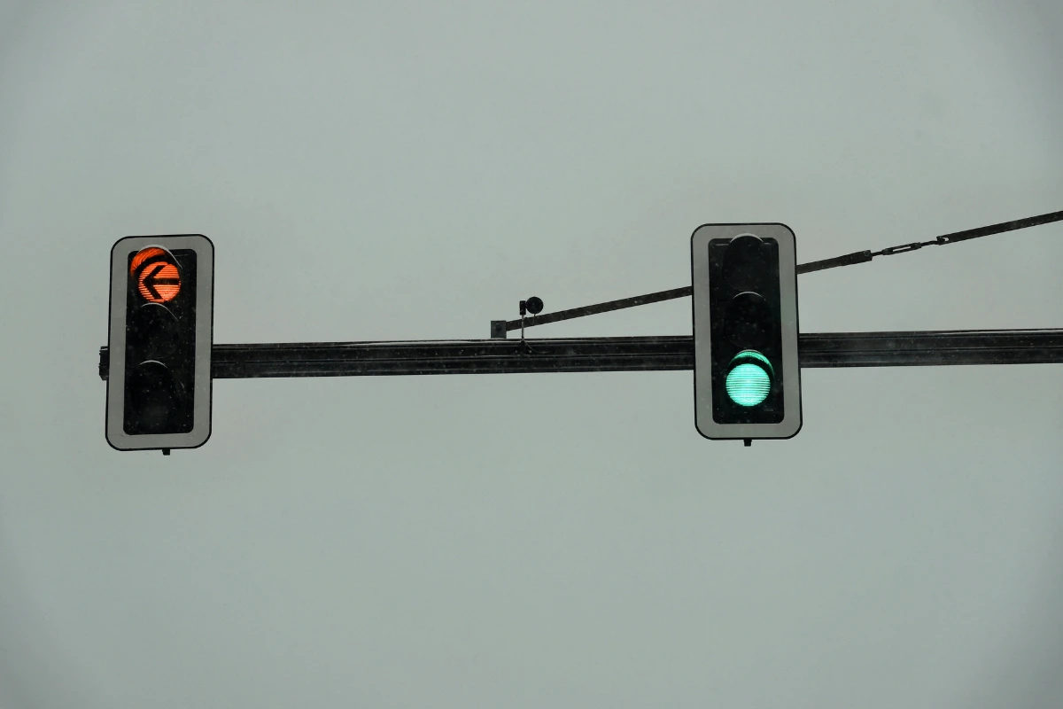 Two traffic lights showing a green light and a left turn arrow, symbolizing the rules self-made millionaires follow when making financial decisions.