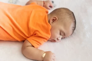 A baby sleeping peacefully during nap time, representing how busy parents can use quiet moments to learn how to create passive income at nap time through digital products.